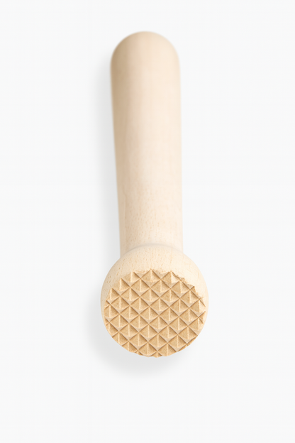 Drewniany tłuczek barmański z gładką rączką i ryflowaną końcówką do rozgniatania owoców i przypraw – wykonany z naturalnego drewna bukowego, widok od czoła na białym tle.